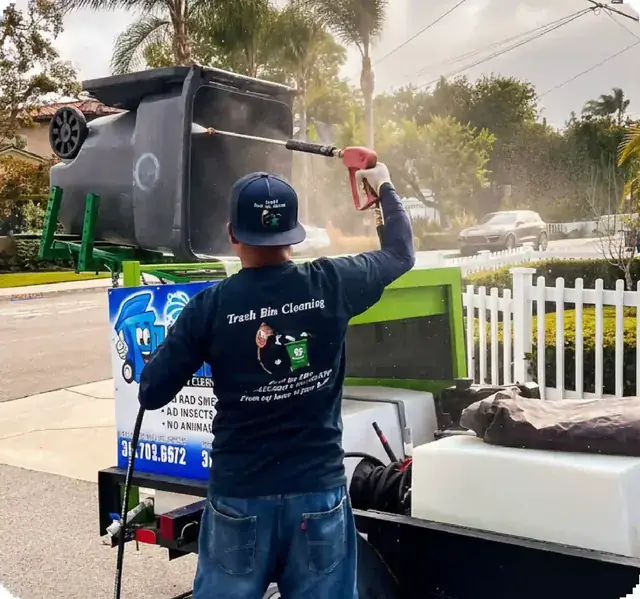 Zafra Trash Bin Cleaning pressure washing a cart off their trailer