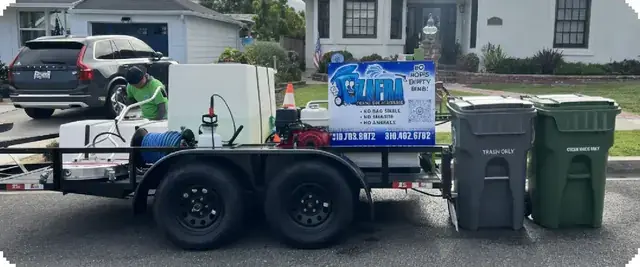 A bin cleaning trailer parked next to clean carts